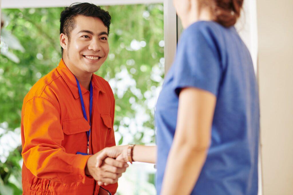 Service worker shaking hand of customer
